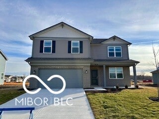 view of front of house with a garage and a front lawn