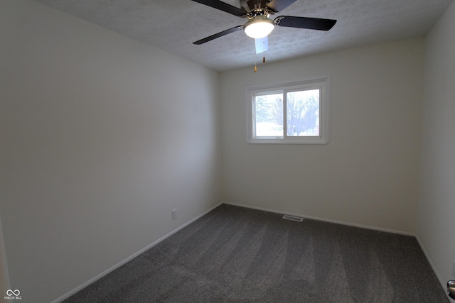 carpeted empty room with a textured ceiling