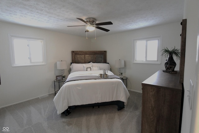 bedroom featuring ceiling fan, carpet flooring, and a textured ceiling