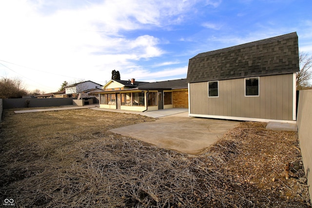 back of property with a patio