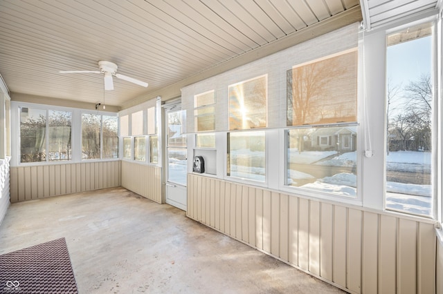 unfurnished sunroom with ceiling fan