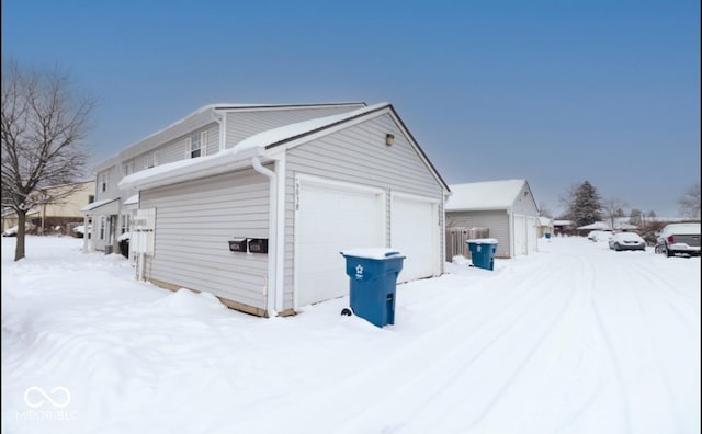 view of snowy exterior with a garage