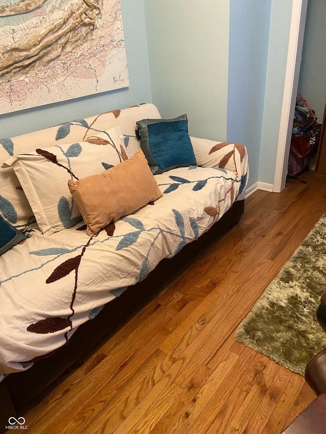 bedroom with a closet and hardwood / wood-style flooring