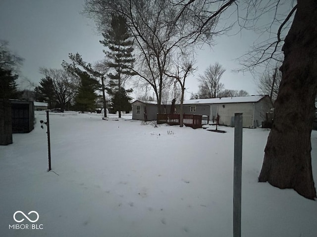 snowy yard with a deck