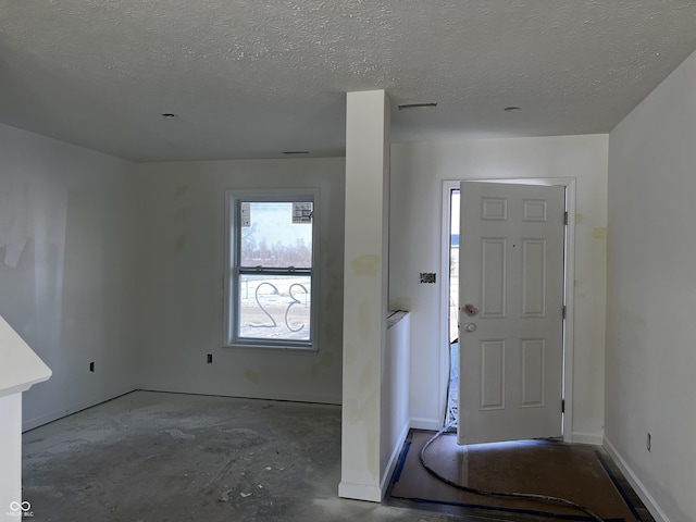 entrance foyer featuring a textured ceiling