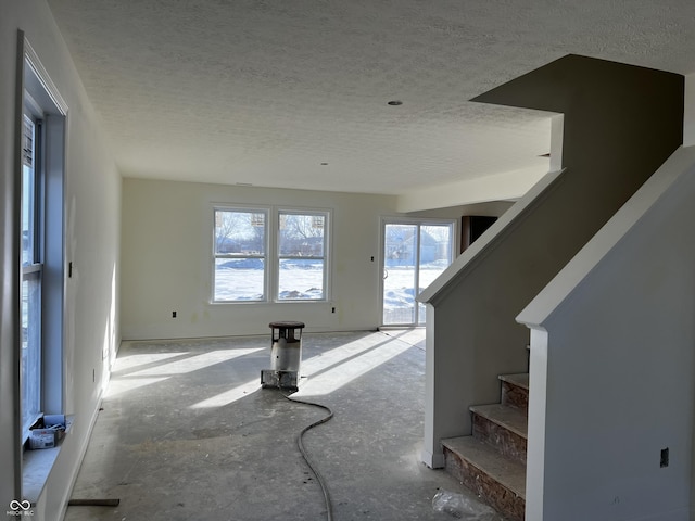 unfurnished living room with a textured ceiling