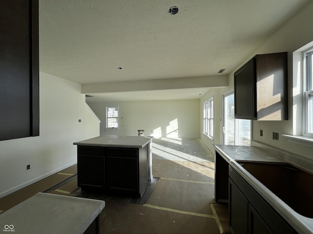 kitchen with a kitchen island and a textured ceiling