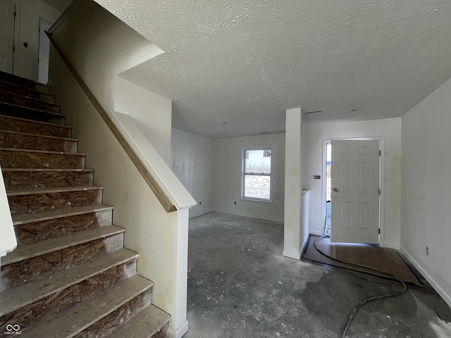 foyer with a textured ceiling