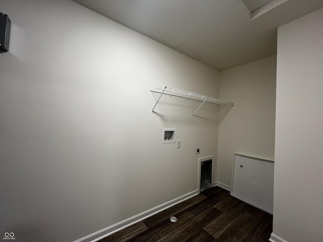 clothes washing area featuring dark wood-style floors, washer hookup, electric dryer hookup, laundry area, and baseboards