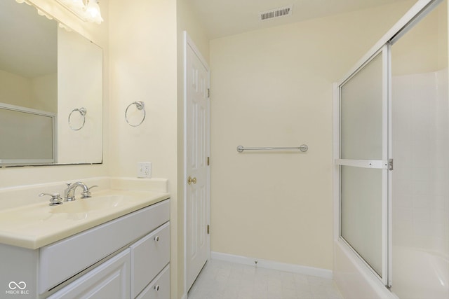 bathroom with enclosed tub / shower combo and vanity