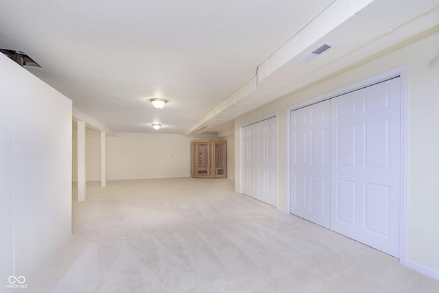 basement featuring light colored carpet