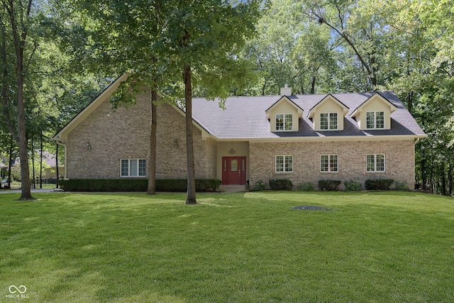 cape cod home featuring a front yard