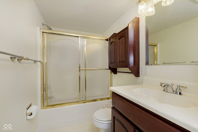 full bathroom with enclosed tub / shower combo, vanity, and toilet