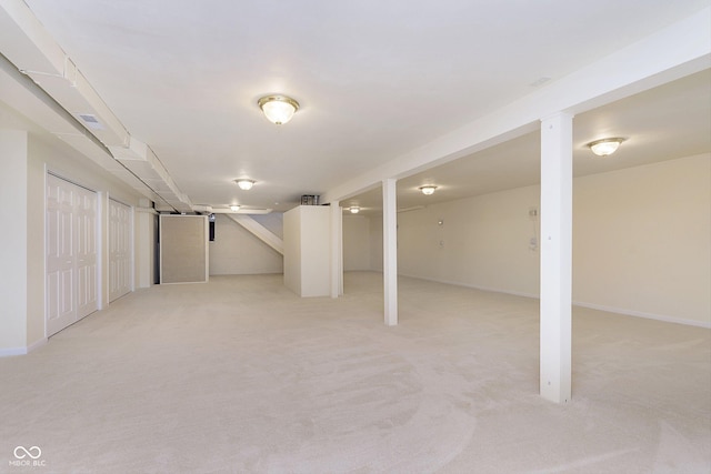 basement featuring light carpet