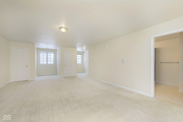 unfurnished room with light carpet