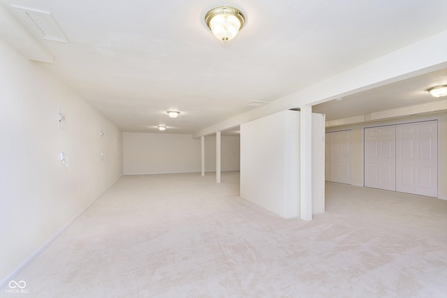 basement featuring light colored carpet