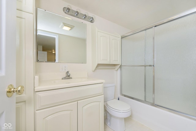 full bathroom featuring toilet, tile patterned floors, enclosed tub / shower combo, and vanity