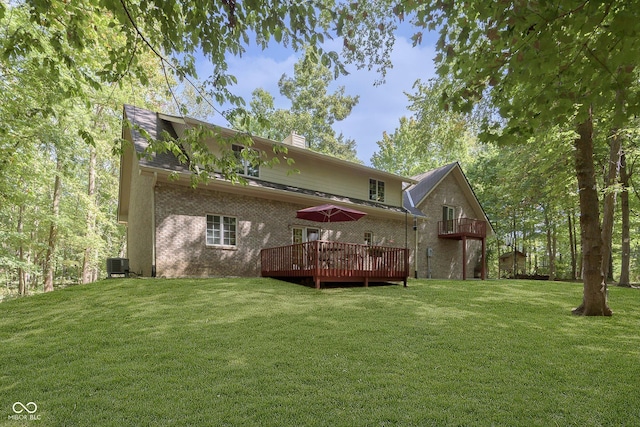 rear view of house featuring a wooden deck, a lawn, and central AC