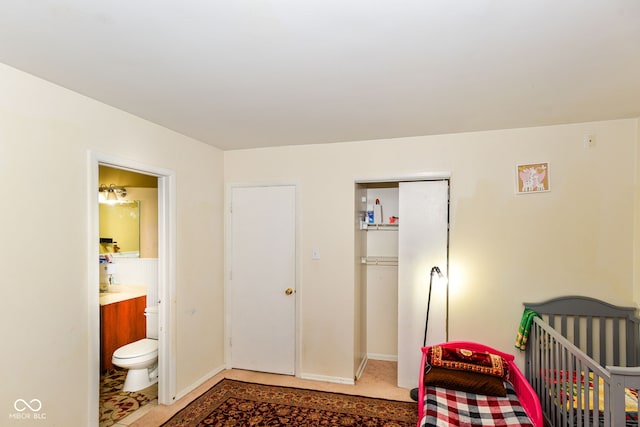 bedroom with ensuite bathroom and a nursery area