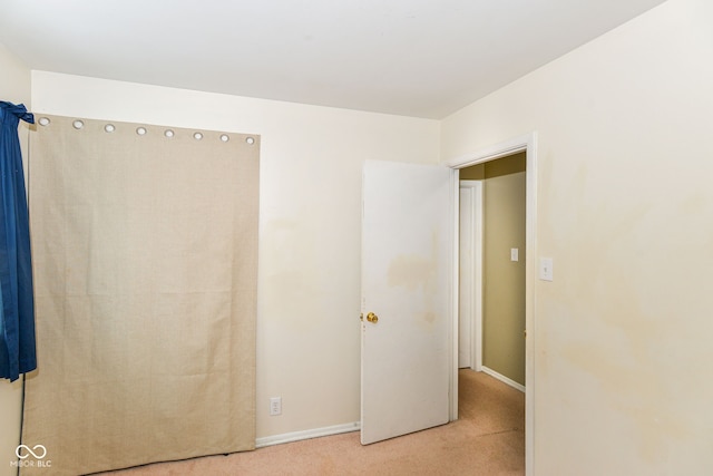 unfurnished bedroom with light carpet