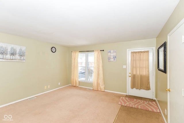 view of carpeted foyer entrance