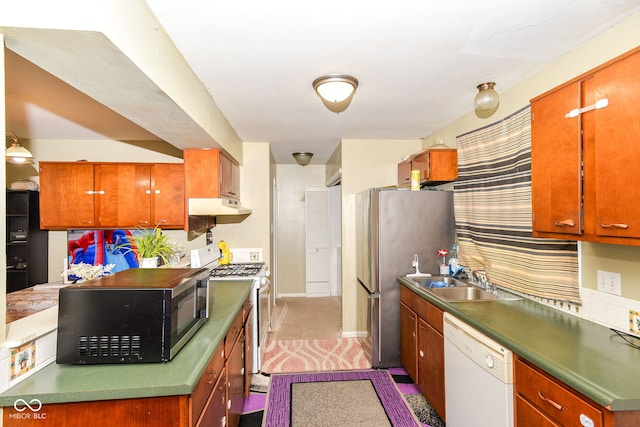 kitchen featuring white dishwasher, sink, stainless steel fridge, and gas range oven