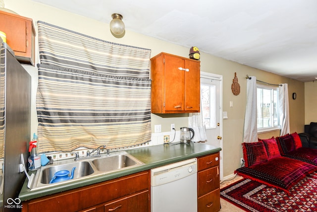 kitchen featuring white dishwasher and sink