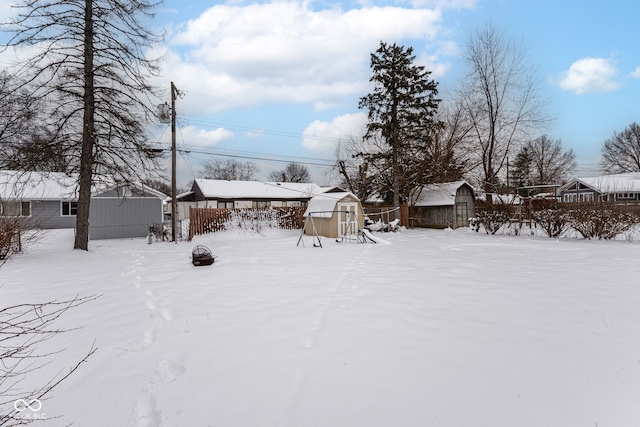 snowy yard with a playground