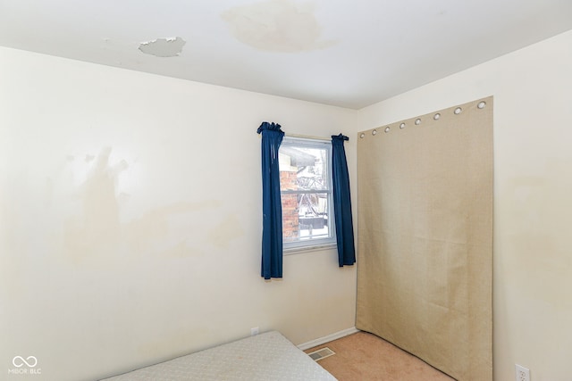 bedroom with light carpet