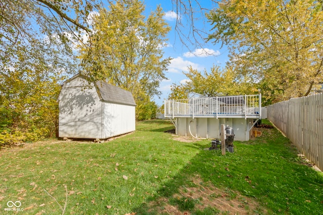 view of yard featuring a deck and a shed