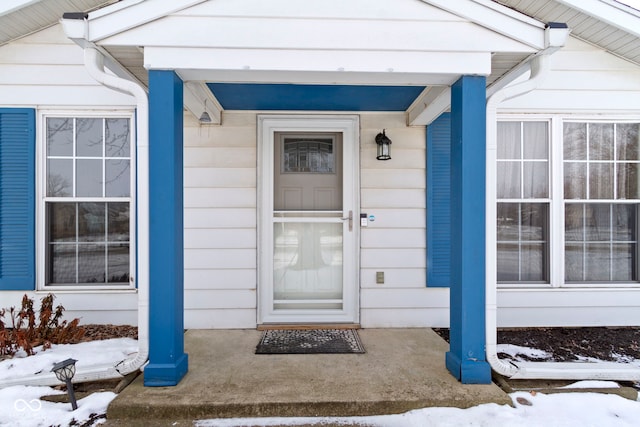 view of snow covered property entrance