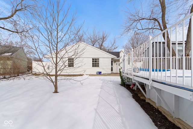 view of snowy exterior with a swimming pool