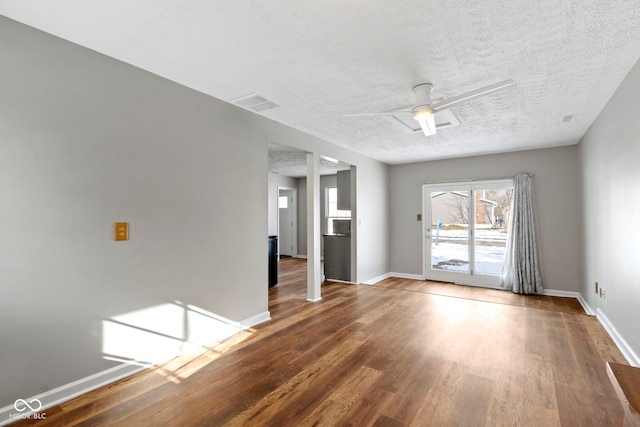 unfurnished room featuring hardwood / wood-style flooring, ceiling fan, and a textured ceiling