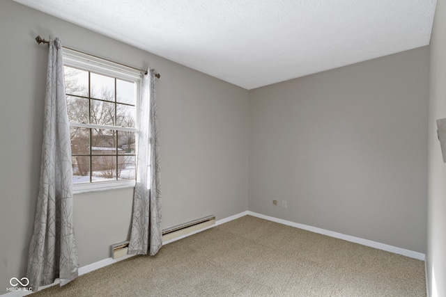 spare room featuring baseboard heating, a healthy amount of sunlight, and carpet