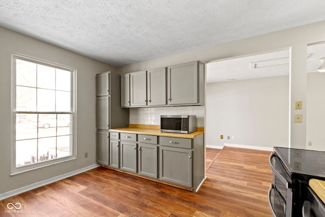 kitchen featuring plenty of natural light, gray cabinetry, and stainless steel appliances