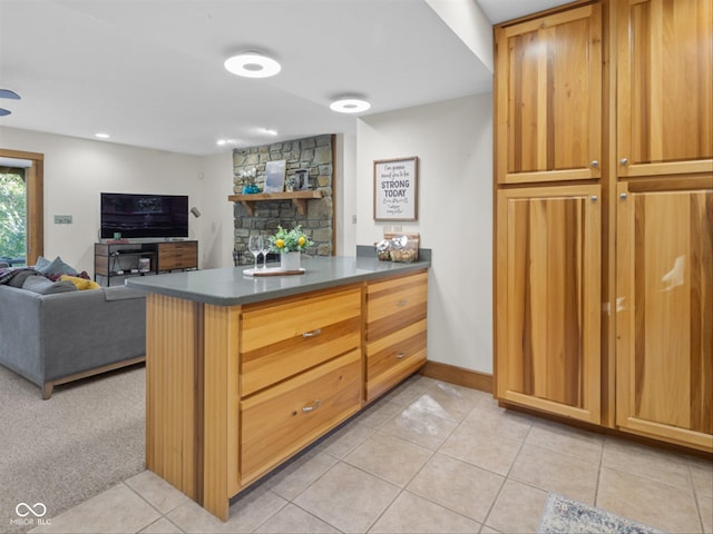 kitchen featuring light colored carpet and kitchen peninsula