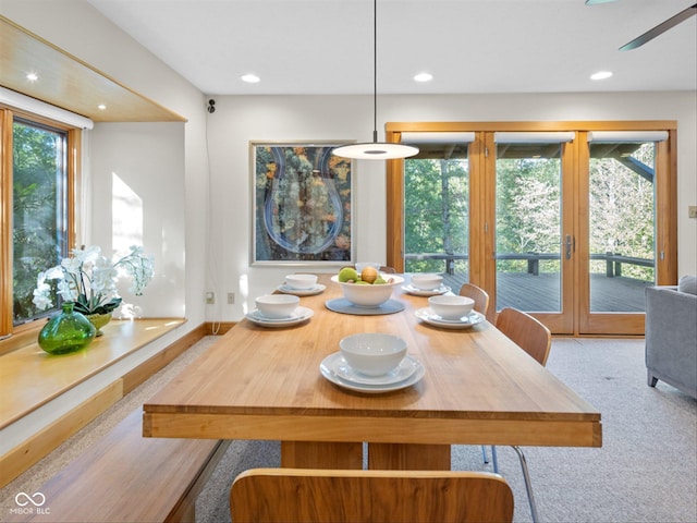 dining space with light carpet and a wealth of natural light