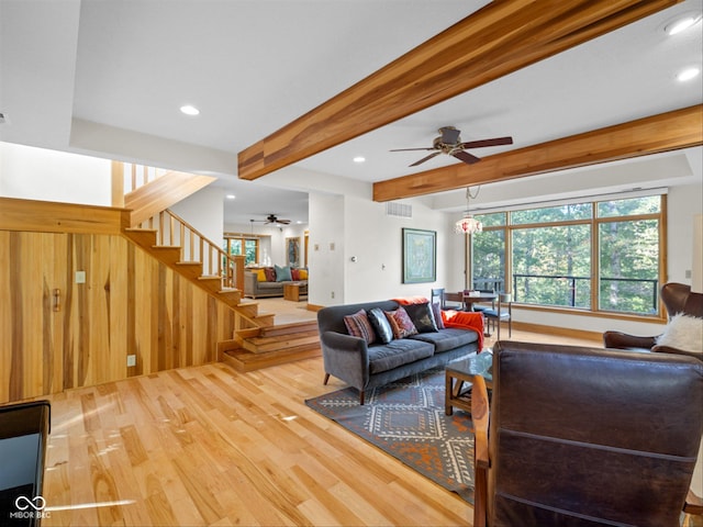 living room featuring beam ceiling, ceiling fan, and hardwood / wood-style flooring