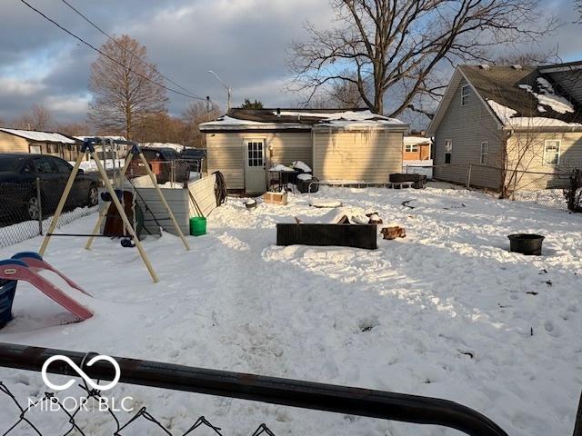 view of snow covered rear of property