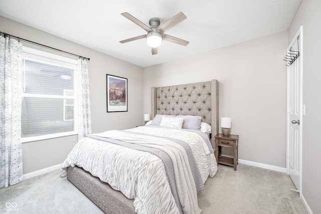 bedroom with light carpet and ceiling fan