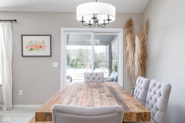 carpeted dining space featuring a notable chandelier