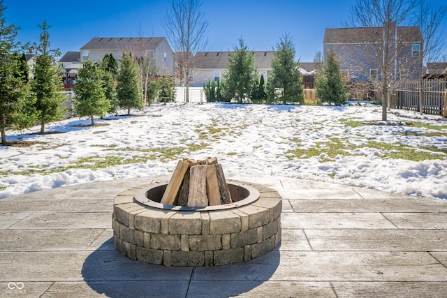 snowy yard with an outdoor fire pit