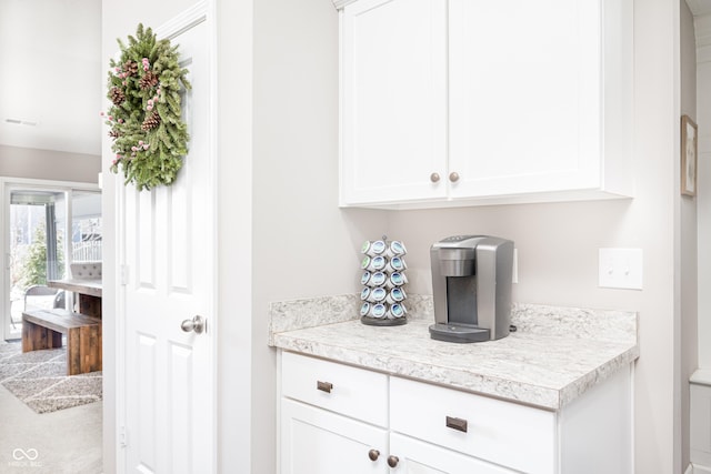 bar featuring white cabinetry