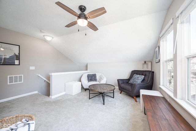 living area with lofted ceiling and light colored carpet