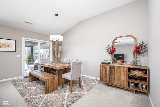 dining space with vaulted ceiling, an inviting chandelier, and carpet floors