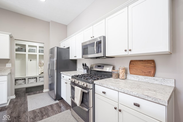 kitchen featuring dark wood-type flooring, stainless steel appliances, and white cabinets