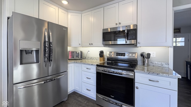 kitchen featuring white cabinets and appliances with stainless steel finishes