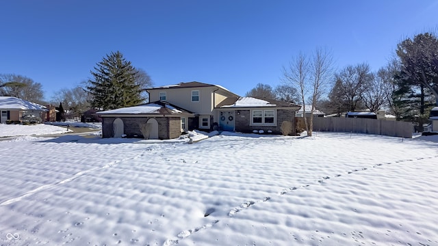 view of snow covered rear of property