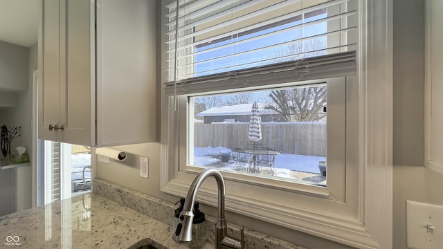 details featuring light stone countertops