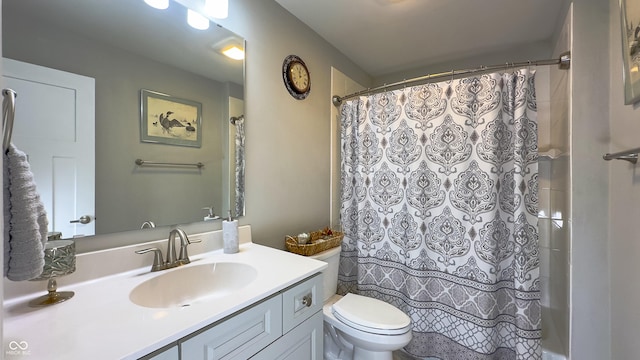 bathroom featuring vanity, a shower with shower curtain, and toilet